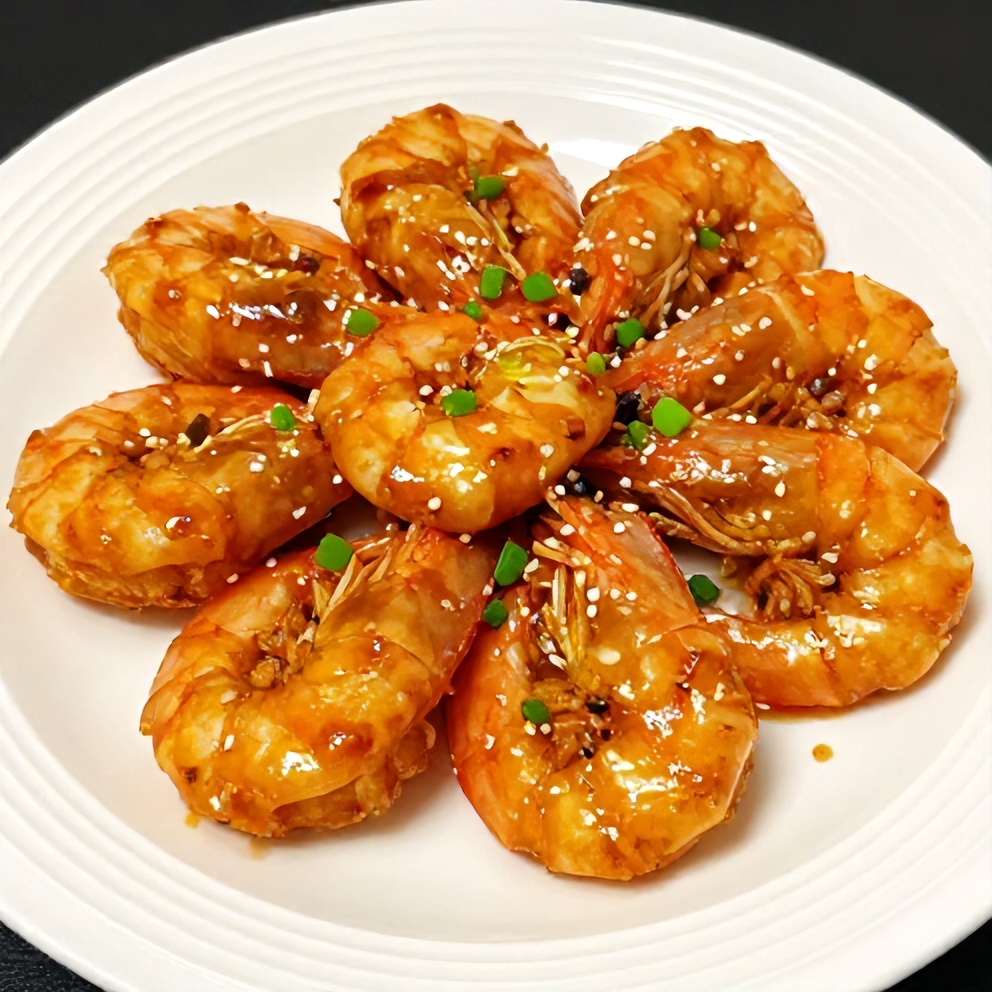 Plated honey garlic shrimp with green onions on a white plate