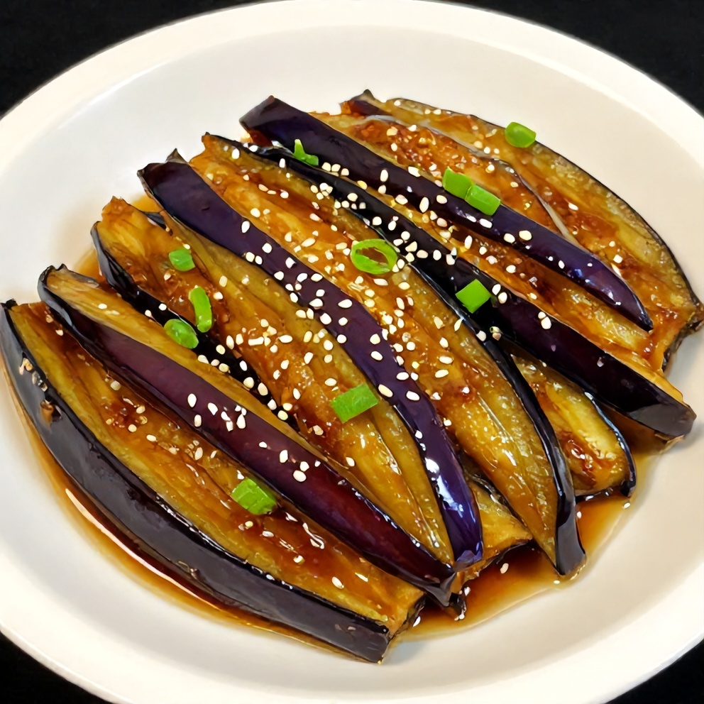 Plated serving of miso glazed eggplant with green onions on a white plate