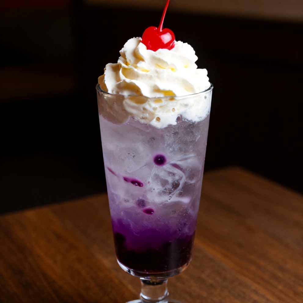 Italian cream soda with blueberry syrup, topped with whipped cream and a cherry