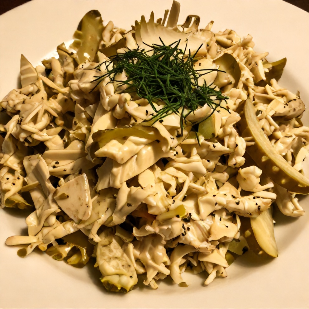 Plated serving of dill pickle coleslaw on a white plate, with a sprinkle of fresh dill as garnish, lit by warm side lighting